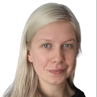 A smiling white woman with long blond hair wearing a black shirt.